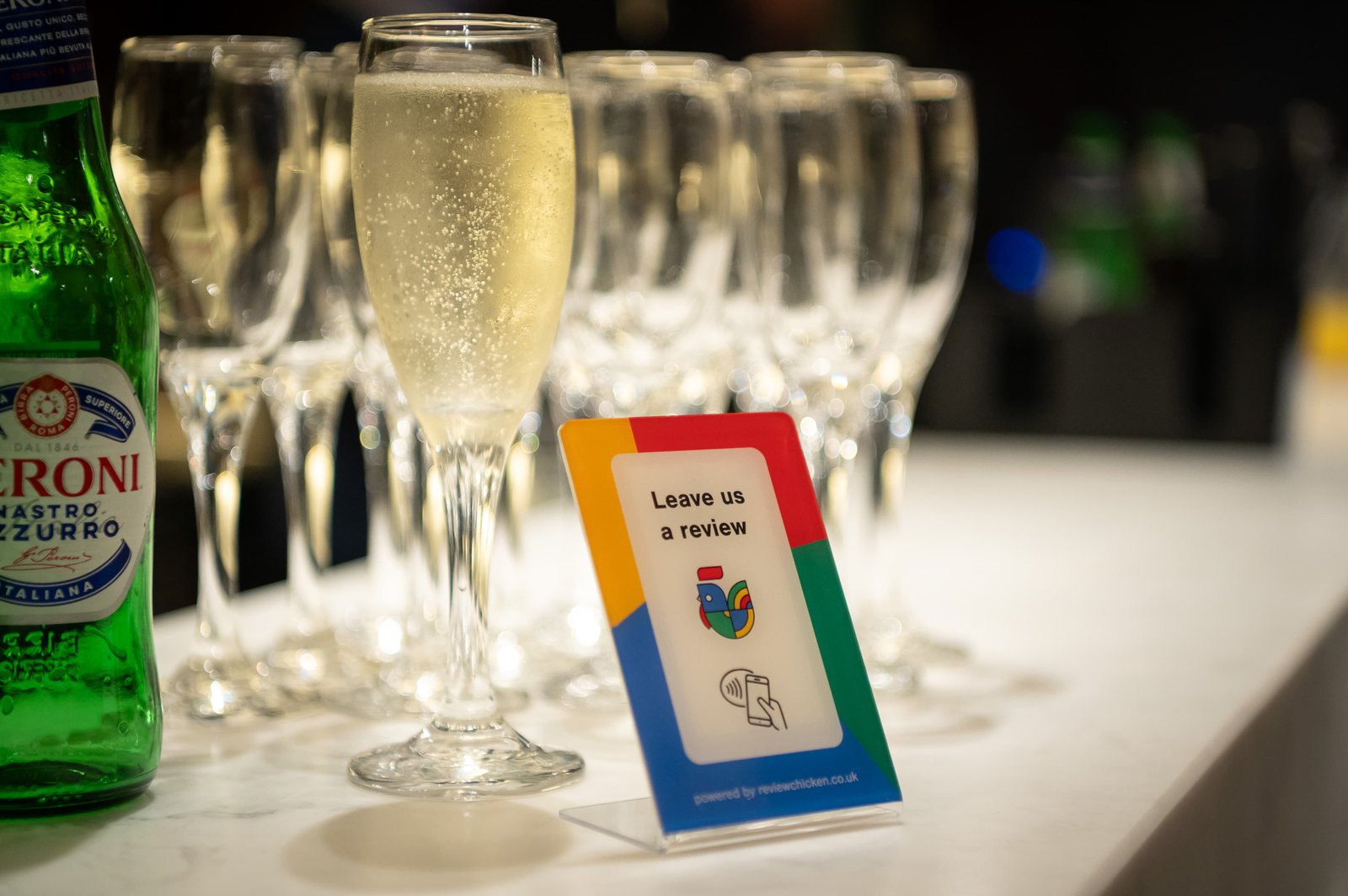 Customer tapping the Review Chicken NFC stand to leave a Google review. Helps local businesses get more five-star reviews and rank higher on Google.